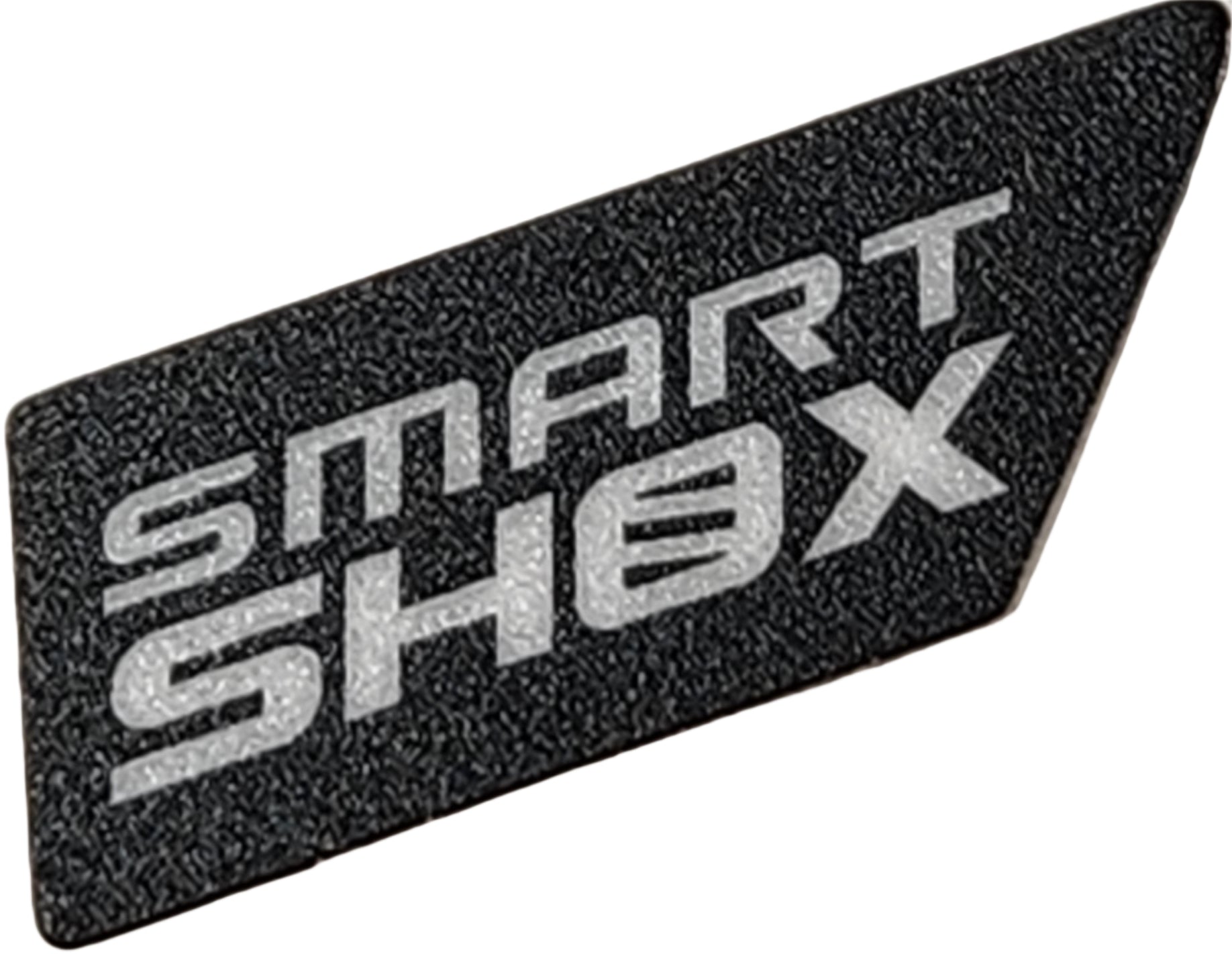 The SMART SHOX Decal by Can-Am is a black, textured badge with bold silver lettering and a stylized Ø—an ideal OEM ATV accessories upgrade for your Can-Am UTV.