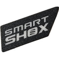 The SMART SHOX Decal by Can-Am is a black, textured badge with bold silver lettering and a stylized Ø—an ideal OEM ATV accessories upgrade for your Can-Am UTV.