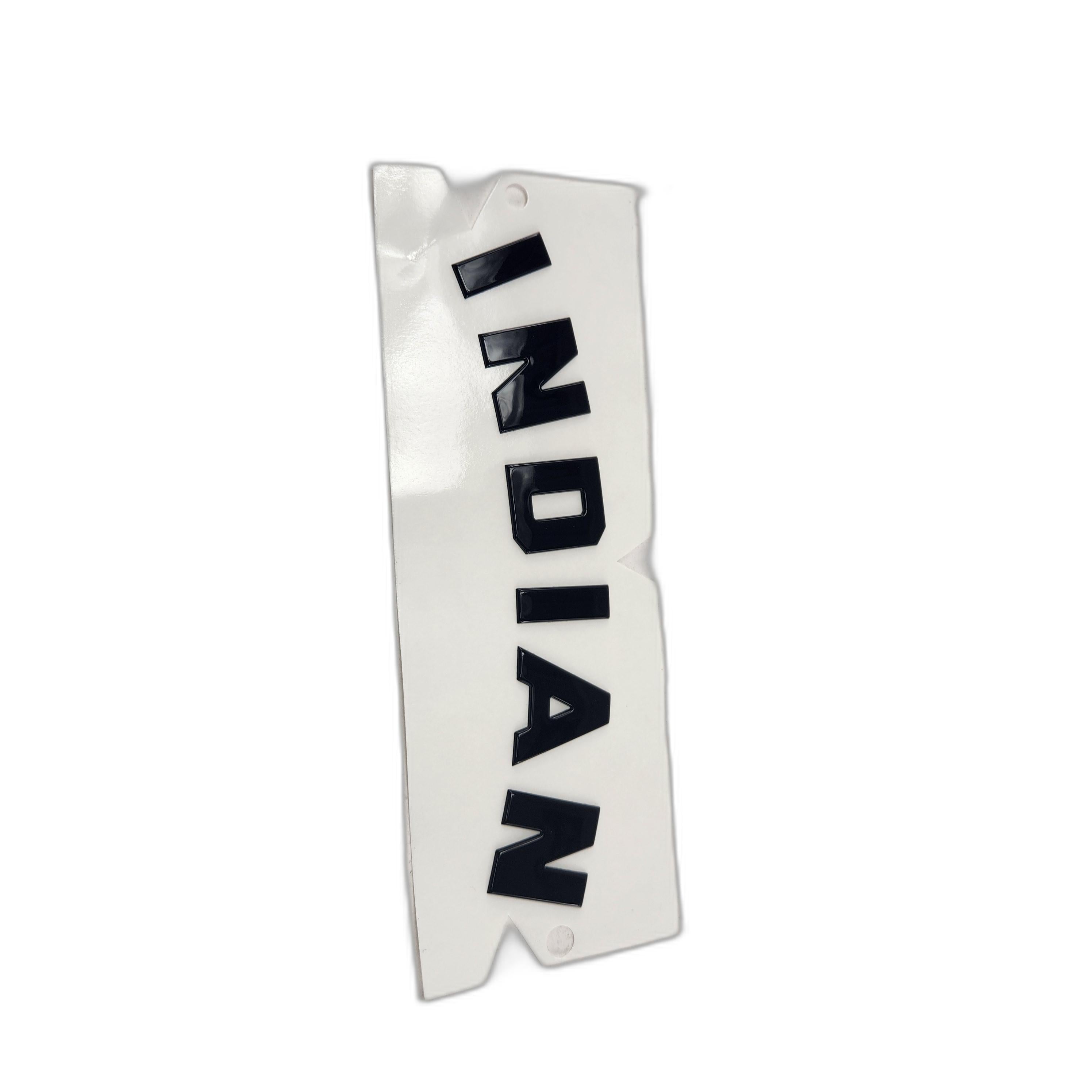 A black tank badge by Polaris featuring INDIAN in bold block letters only.