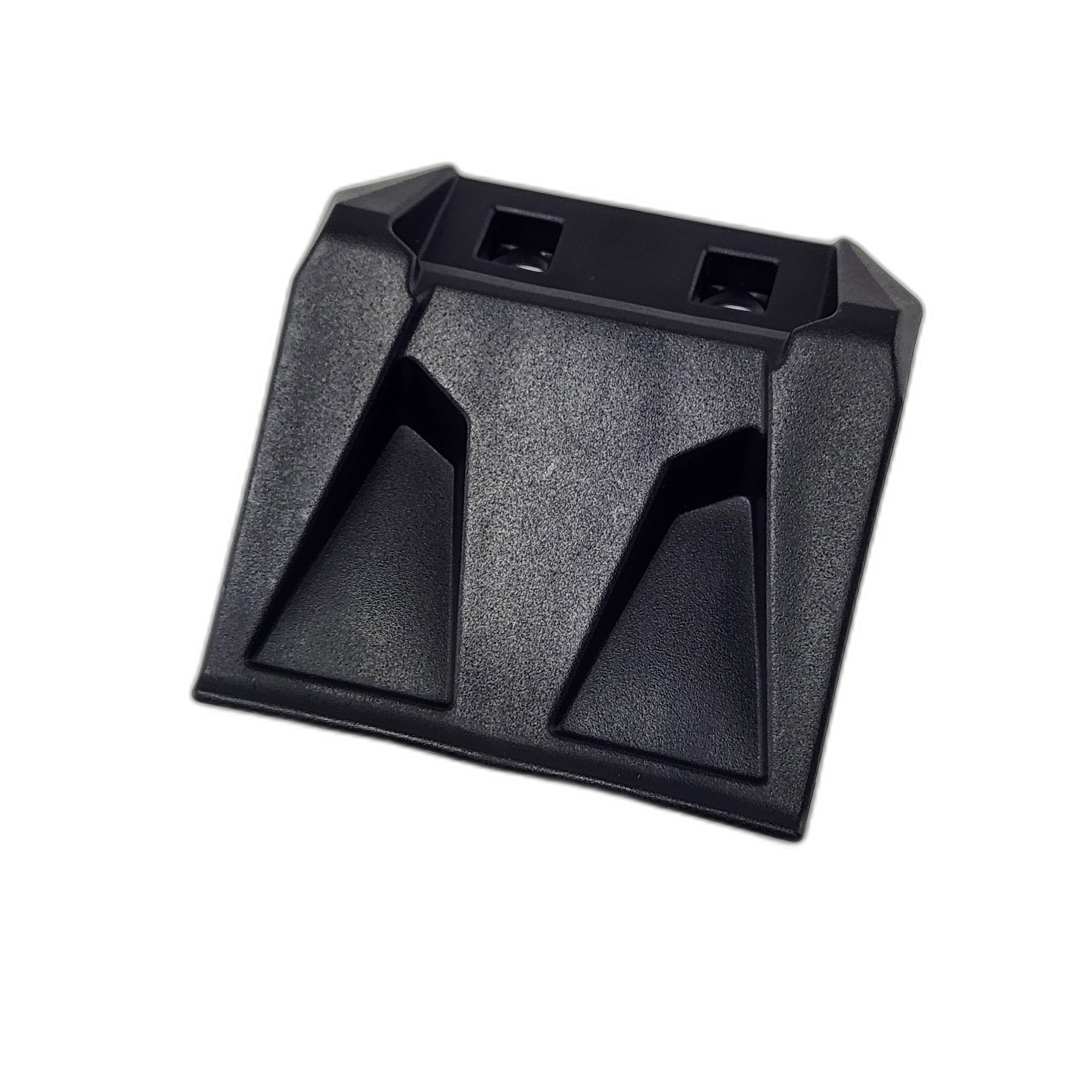 A black plastic Upper Window Clamp by Polaris with a modern, angular design and textured surface is shown from a slight angle on a white background, reflecting the precision typical of OEM Polaris accessories.
