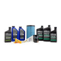 Polaris Ranger maintenance kit with oil bottles, blue air filter, black oil filter, and green coolant bottles arranged on.