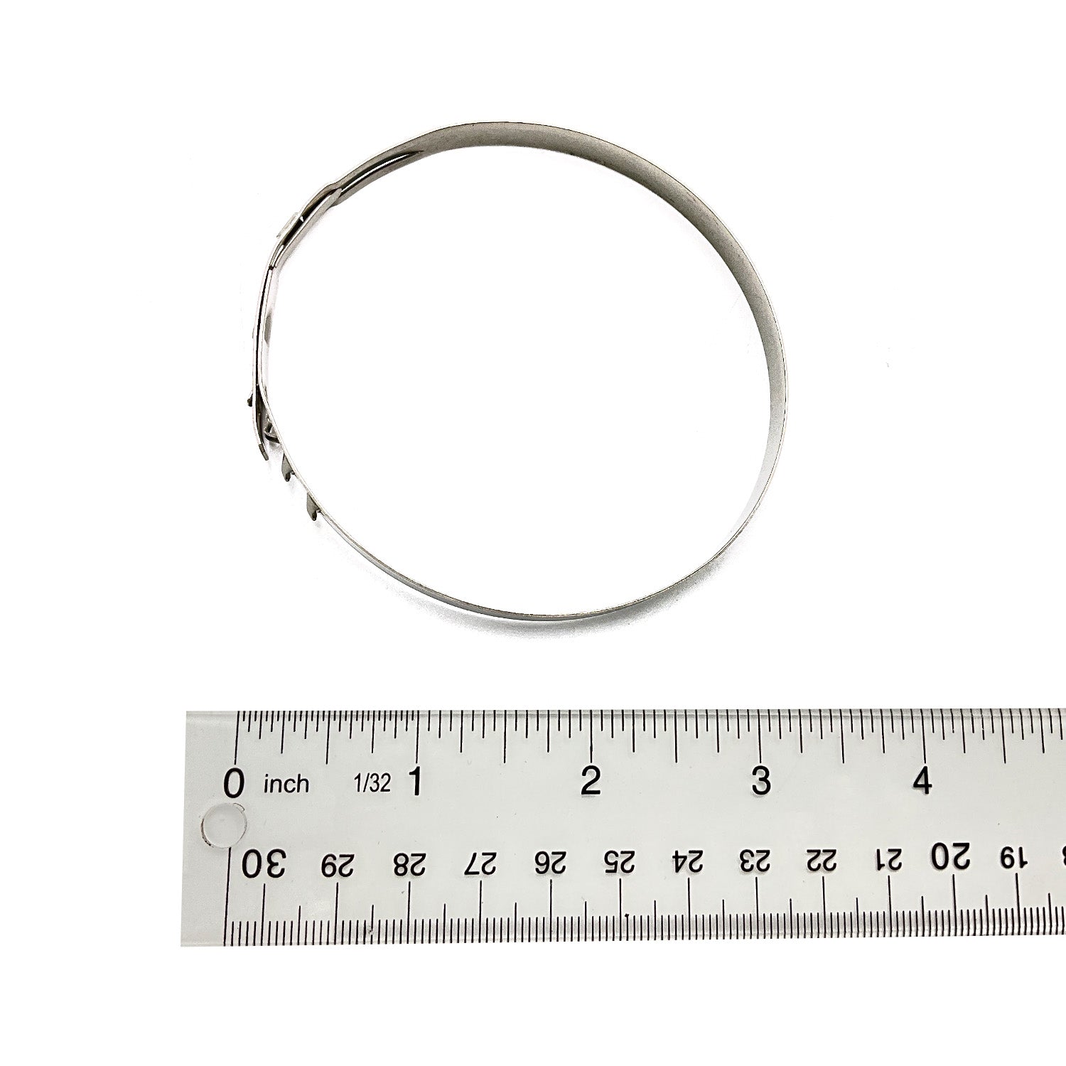 Silver metal large clamp with slotted tightening mechanism, shown next to clear ruler for scale.