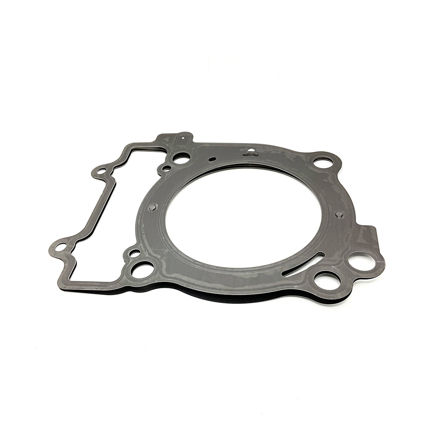 Gray metal head gasket with circular and irregular shaped cutouts, flat design.