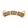 Curved brake pad with three rectangular friction segments on a golden metal backing plate.