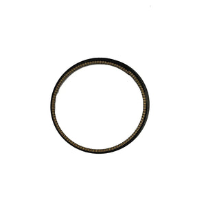 Black metal piston ring with textured surface and uniform circular shape.