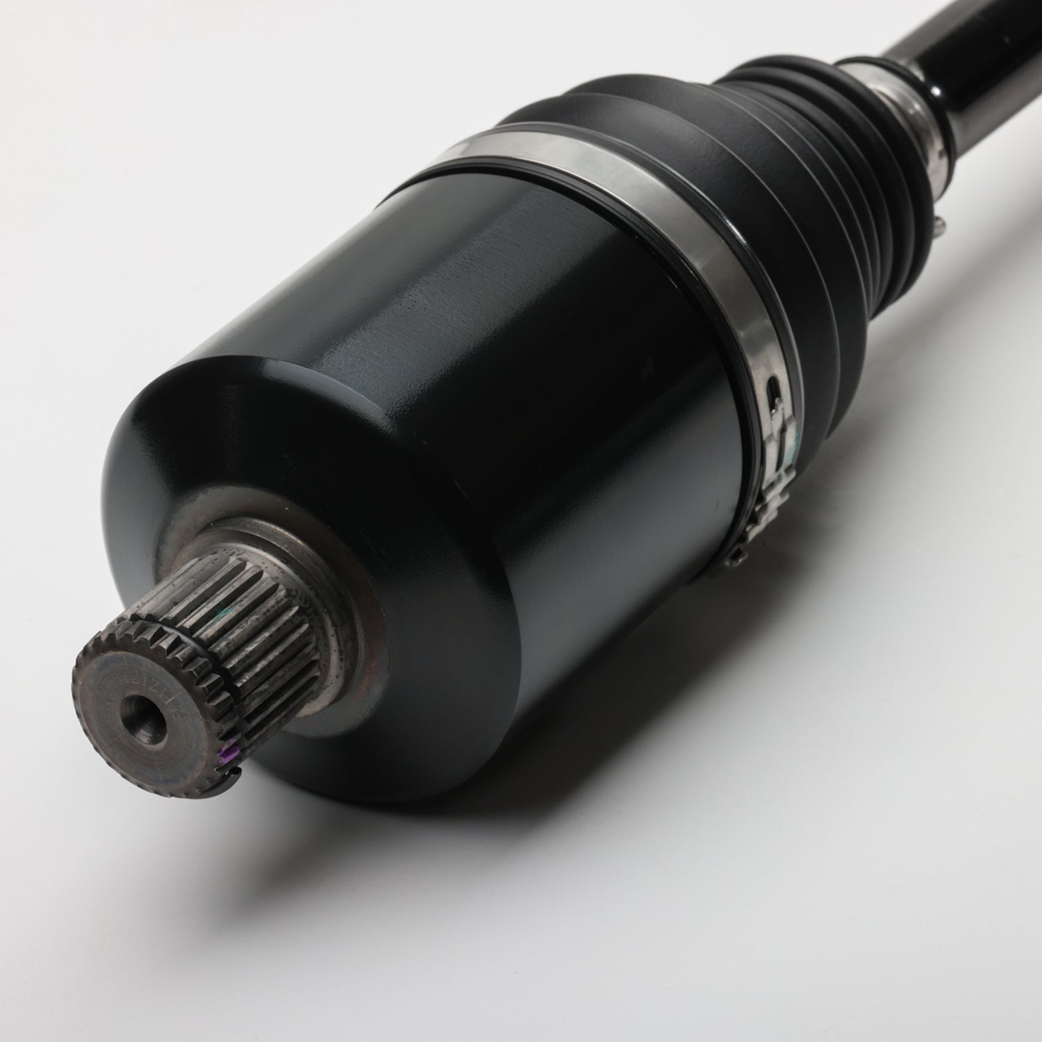 Black metal front CV shaft with splined end and protective rubber boot clamp.