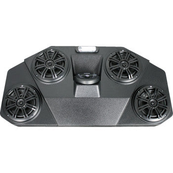 Black audio mini system with four round speakers mounted on a trapezoid housing with textured front panel.