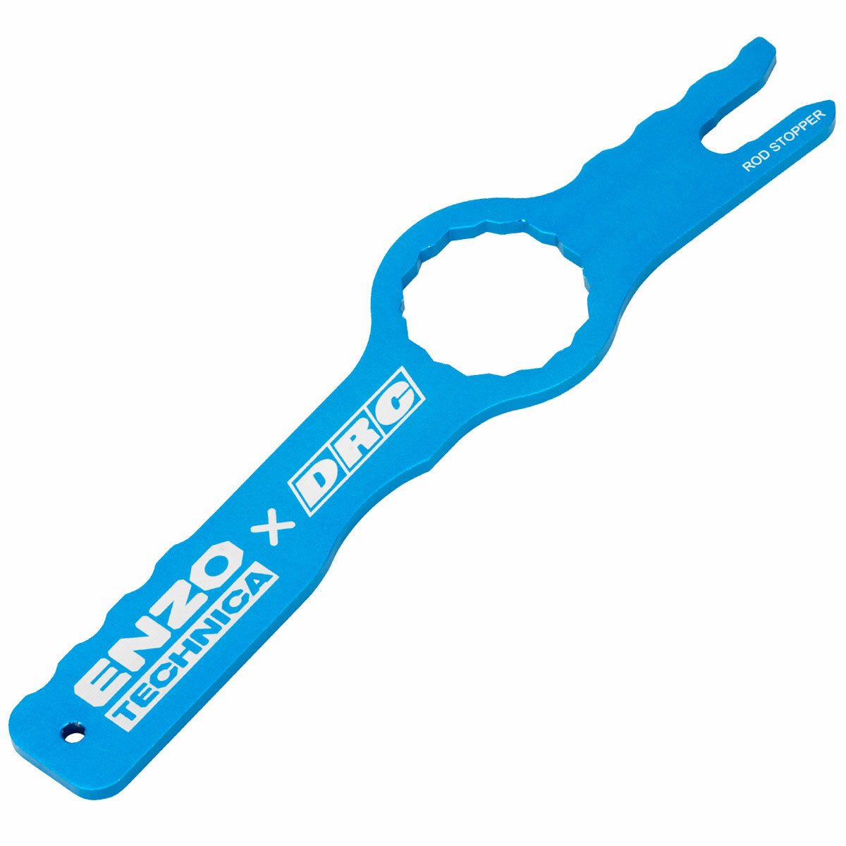 The Fork Cap Spinner by DRC is a blue, flat tool labeled “ENZO TECHNICA x DRC” and “ROD STOPPER,” featuring a round opening and notched end for gripping or holding cylindrical objects.