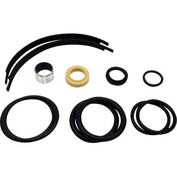 The Complete Rebuild Kit by Hygear Suspension includes assorted black rubber O-rings, two thin black strips, one beige ring, and one silver ring—perfect for shock shaft maintenance—all displayed on a white background.
