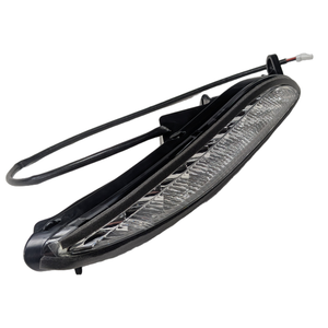 Right-side motorcycle turn signal with clear lens, black housing, and attached wiring harness.