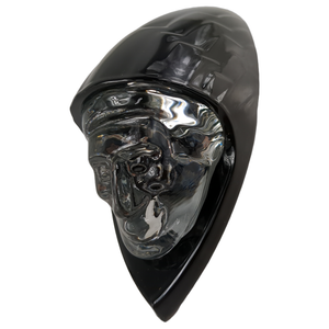 Glossy black motorcycle fender headdress with sculpted chrome skull face detail.