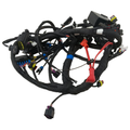 Black motorcycle wiring harness with multiple connectors and protective coverings.