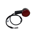 The Turn Signal Assembly Rr Stt Cnd Left Hand Side (Black) by Polaris features a red LED round tail light, black housing, attached wire, gray connector, and QR code label. Compatible with Indian motorcycles and meets Polaris OEM standards for rear signaling.