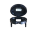 A black plastic Asm-Chrg Port 12V Cap Prem Ind by Polaris with a hinged lid open, revealing a white label with barcode and text inside. This OEM part features two holes and is shown isolated on a white background.
