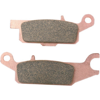 Copper-colored metal backing plates with dark, textured sintered brake pad surfaces for off-road use.