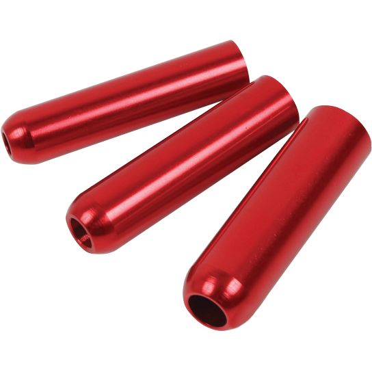 Three shiny red cylindrical metal objects, resembling the Rear Shock Sealhead Insert Kit by DRC, are arranged diagonally on a white background, suggesting use in suspension seal installation.