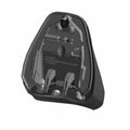 Black plastic underside of a contoured motorcycle driver seat with mounting points and hardware slots.