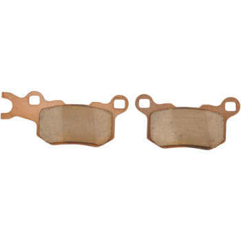 Two Can Am Defender Standard Brake Pads by DP Brakes are shown side by side on a white background, each featuring a copper-colored backing plate and gently worn friction surfaces.