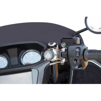 Close-up of a motorcycle handlebar with control switches, bell, speedometer gauges, and the Ambidextrous Mount - iOmount™ - Chrome by Klock Werks prominently displayed on the right-hand grip.