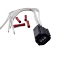 The Idle Air Control Harness by Polaris, in black with four white wires, is shown next to four red wire connectors on a white background.