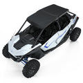 Black poly roof installed on white Polaris off-road UTV with blue accents and rugged tires.