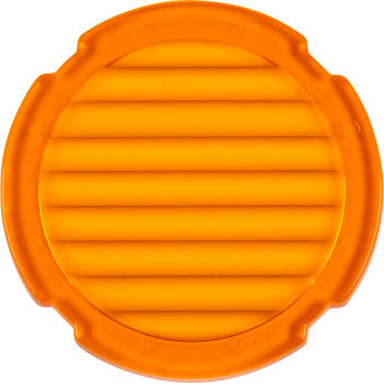 The Lens Amber Flood Light by Heretic is a round, orange plastic replacement lens with ridged grooves and four evenly spaced notches, designed for high light transmission.