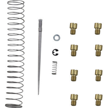 The Yamaha Jet Kit Stage 1 by Dynojet includes two metal springs, a slender needle, a washer, a small retaining clip, and eight brass jets, all arranged in a grid on a white background.