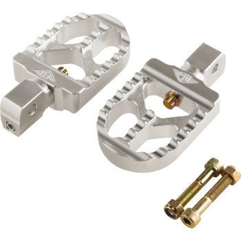 A pair of Serrated Footpegs - Silver- Short by Joker Machine, made from CNC-machined aluminum with a rugged design, displayed with two mounting bolts and nuts on a white background.