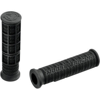 A pair of black ATV Stealth Grips by Moose Offroad, featuring high-traction half-waffle and square grid patterns, flared ends, and crafted from a U.S.-made compound. One grip displays the Moose Racing logo in raised letters.