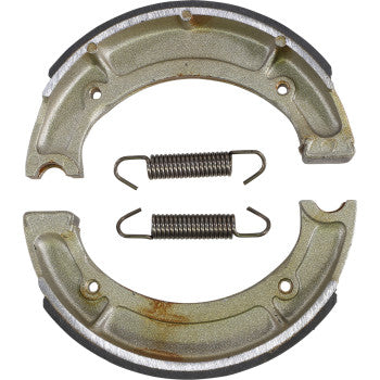 Two metallic semicircular Yamaha Brake Shoes by Dp Brakes and two coiled tension springs on a white background, designed for fade-free performance and dependable drum brake assemblies.