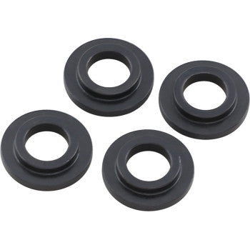 Set of four black circular valve spring locators with a smooth finish and central holes, designed for intake and exhaust use.