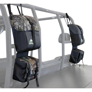 Two Arch Series™ Fender Bags Black by Atv-Tek, made from waterproof tarpaulin, are strapped to the metal frame behind the seats of an off-road utility vehicle for organized gear storage.