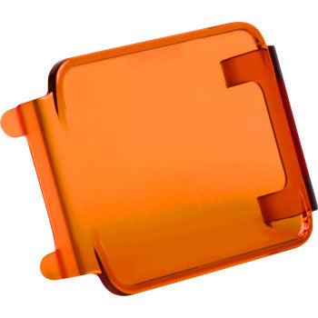 The Light Cover D Series Amber by Rigid Industries is an orange, rectangular polycarbonate snap-on case with rounded edges and two side tabs, offering added protection against a white background.