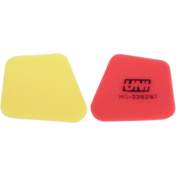 Two irregularly shaped foam filters, yellow and red, are shown side by side. The red one features UNI and NU-2362ST, indicating the Kawasaki Air Filter by Uni Filter, a two-stage air filter designed for superior performance.