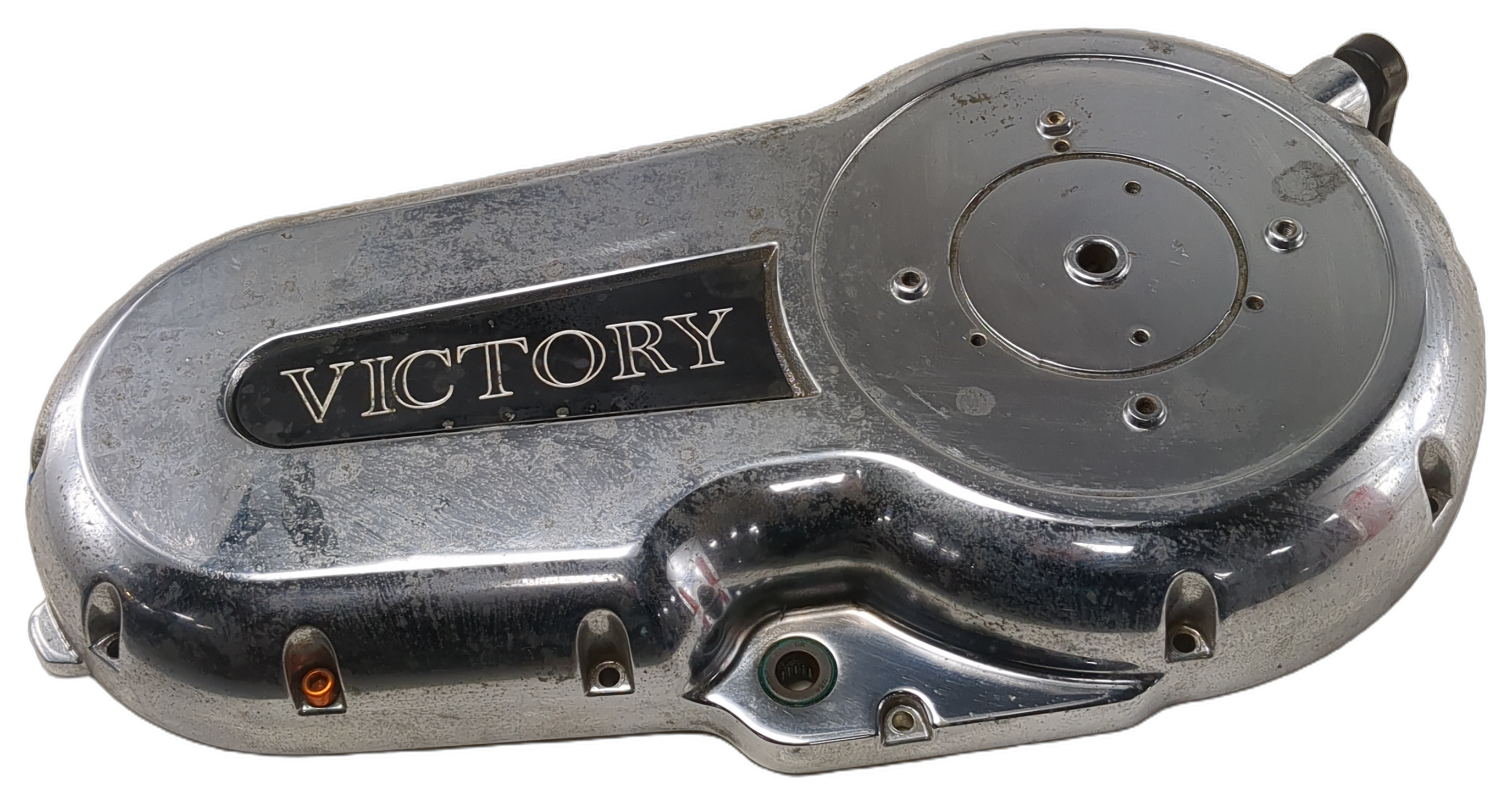 Used chrome Victory motorcycle primary cover with a rounded metal housing, bolt holes, and black logo badge.