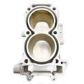 Silver metal cylinder head with two large circular chambers and multiple bolt holes for secure attachment.