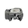 Black front machined motorcycle head cylinder with silver circular metal plate and cooling fins.