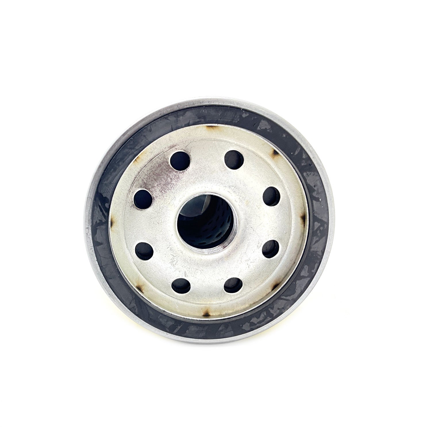 Round metallic oil cartridge with multiple holes around a central threaded opening and black outer rim.