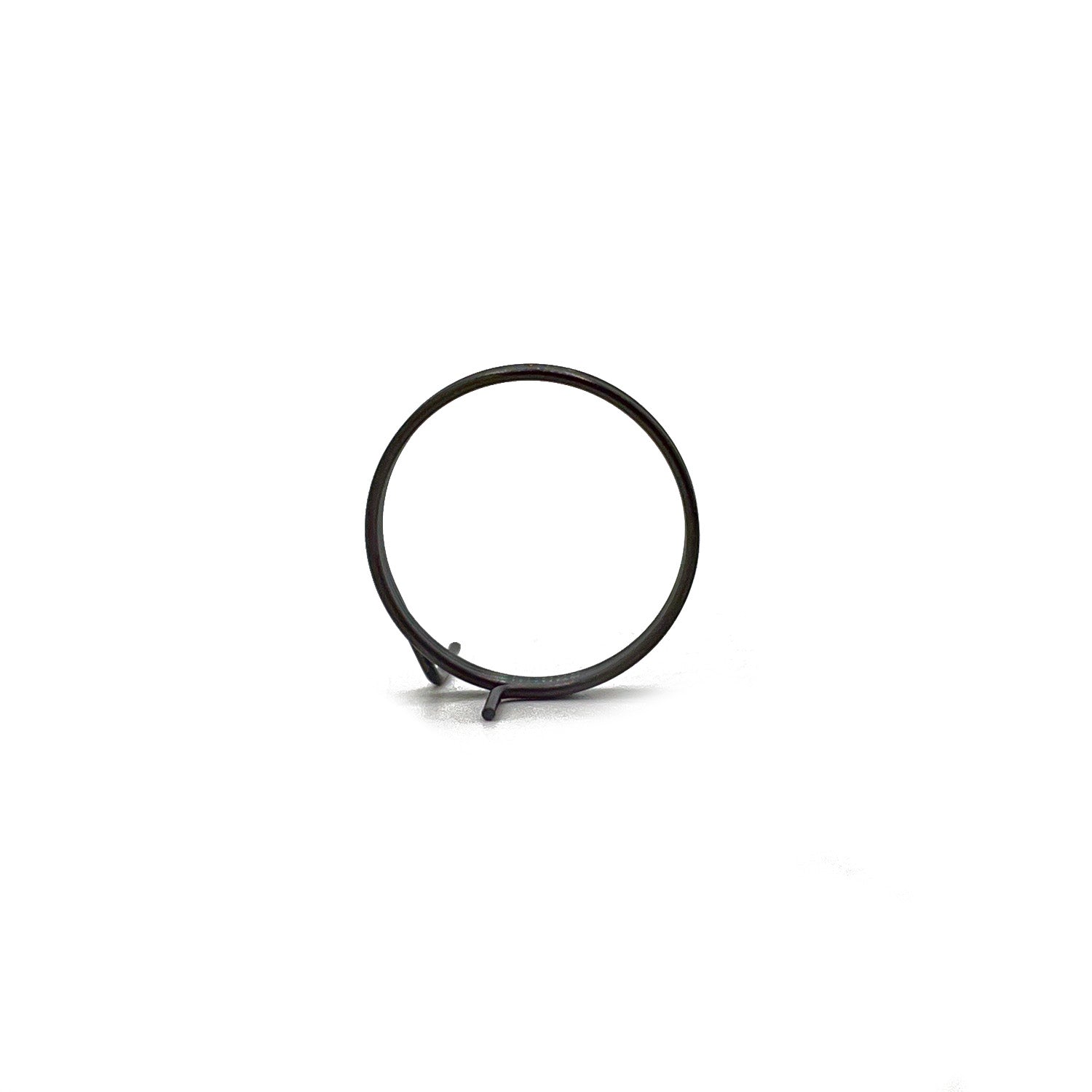 Black metal return spring coil with angled hook end on white background.