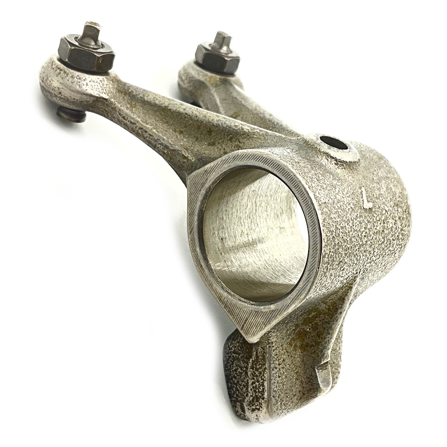 Gray metal exhaust rocker arm with two nuts and a circular pivot hole.