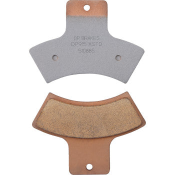 Two metallic Polaris Sintered Brake Pads by DP Brakes are shown: one with a smooth gray surface and stamped text, the other featuring textured friction material on a copper-colored backing plate.