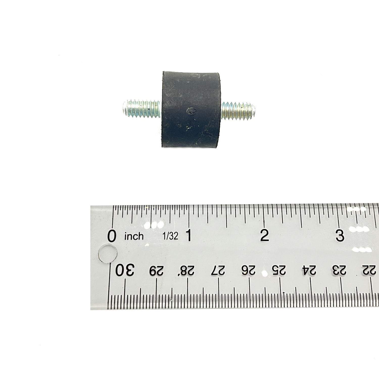 Black cylindrical rubber mount with threaded metal studs on both ends, shown next to a metal ruler for scale.