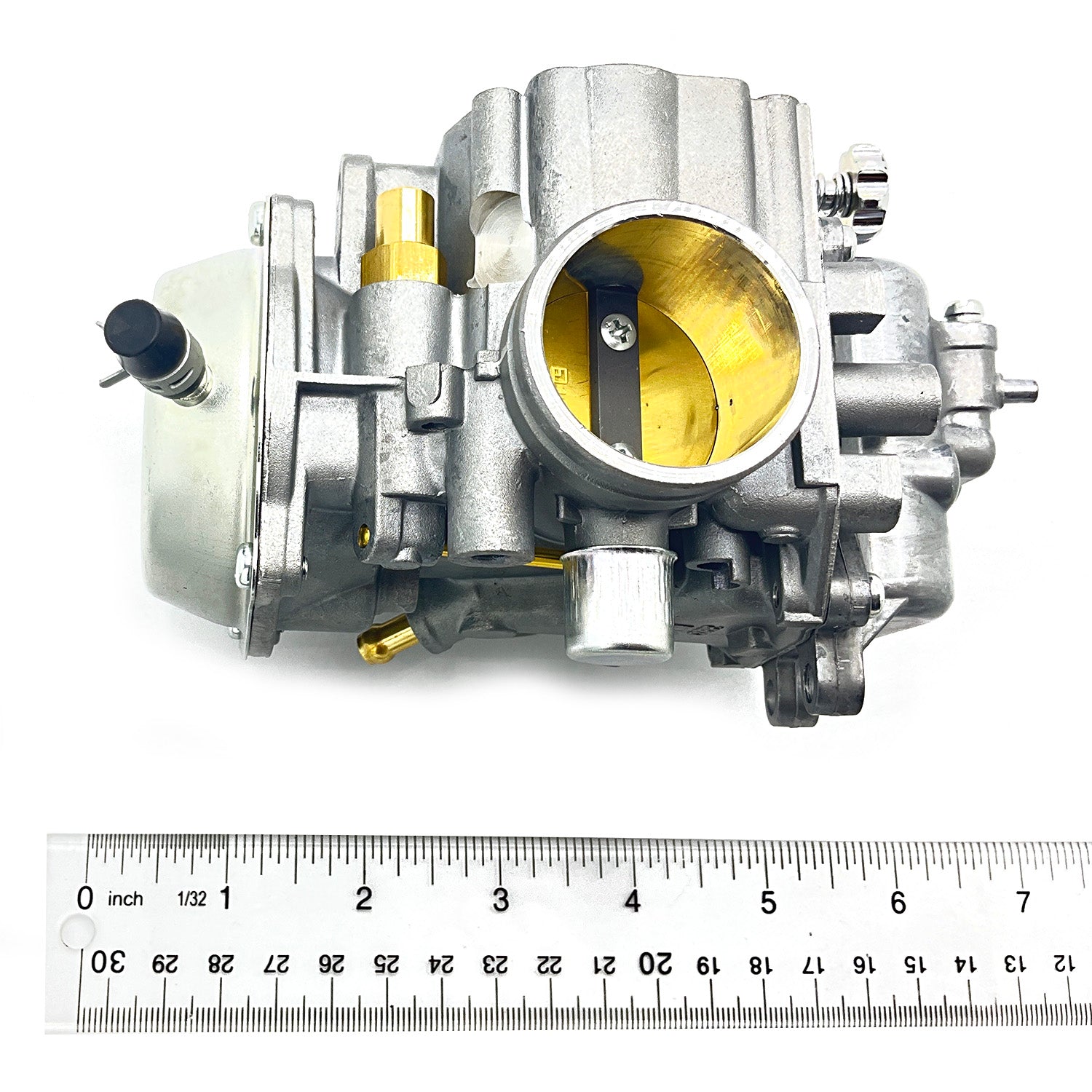 Silver metal carburetor with brass throttle plate and black plastic fuel inlet, shown next to a 30 cm ruler for scale.