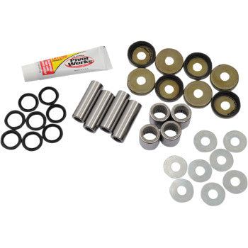 Front lower A-arm bearing kit with metal bushings, black rubber seals, silver cylindrical spacers, washers, and tube of.