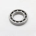 Silver metal ball bearing with visible steel balls and circular outer race.