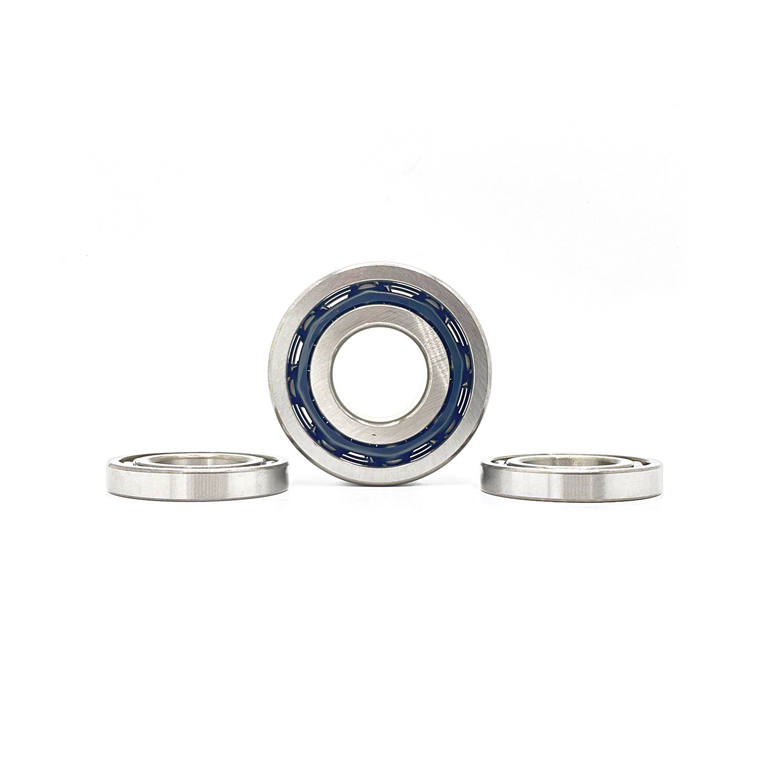 Set of three silver metal pinion bearings with one bearing showing blue inner seals on white background.