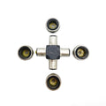 Metal universal joint with four cylindrical caps, cross-shaped body, and visible needle bearings inside caps.