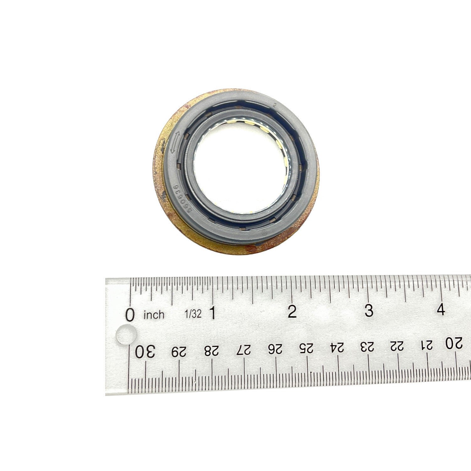 Round black rubber seal with metal flange and triple lip design, next to a ruler for scale.