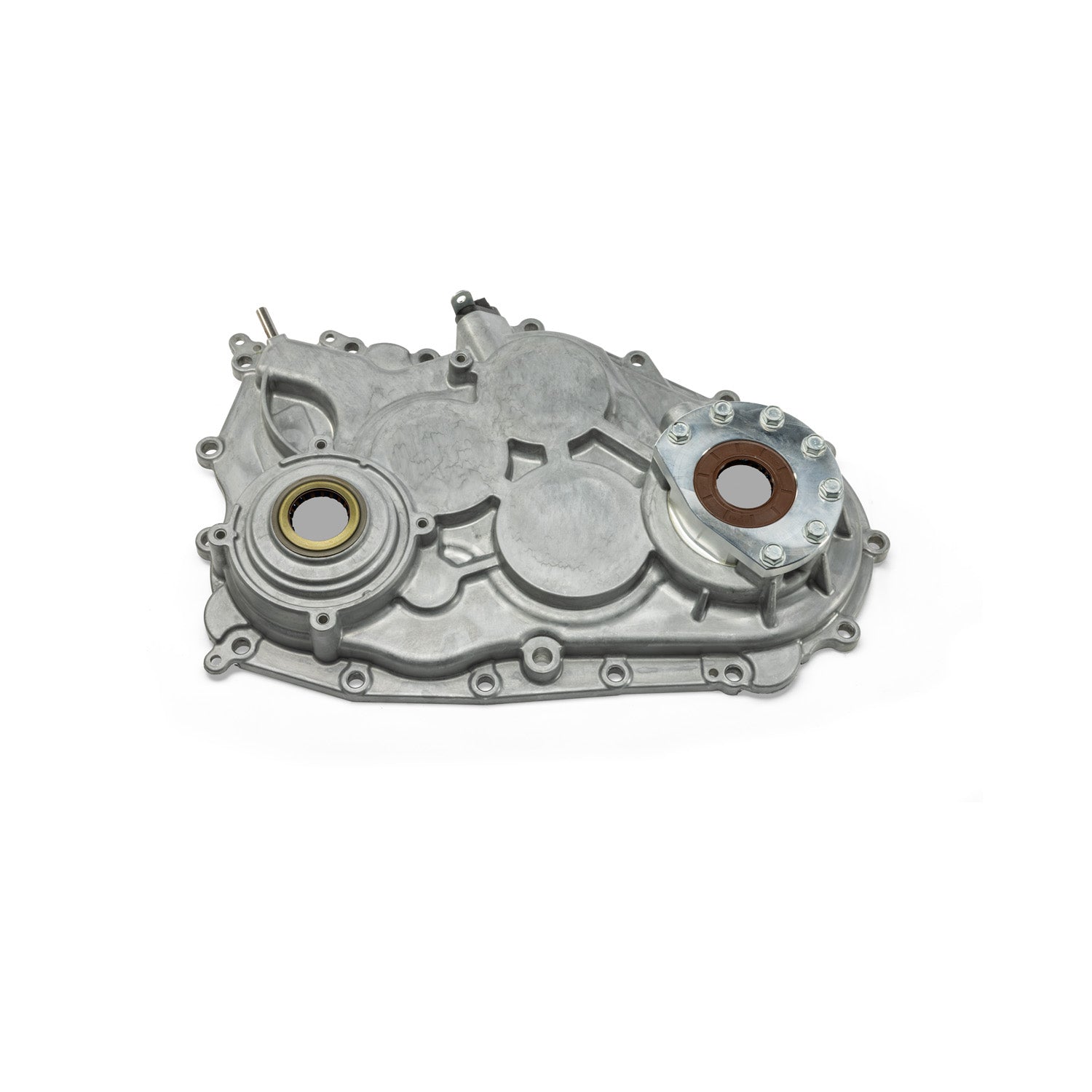 Silver metal main gearcase cover with circular seals and multiple mounting holes.
