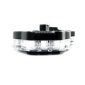 Black and clear round C4 gauge cluster housing with multiple mounting points.